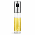 Clear spray bottle with silver top on a white background