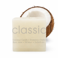 Coconut candle with a half-coconut on a white background