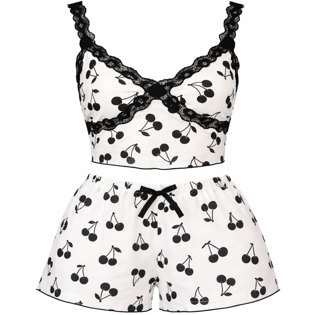 White pajama set with black cherry pattern and lace details on a white background