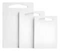 Three white cutting boards of different sizes on a white background