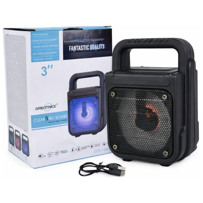 Black portable speaker with handle next to its packaging on a white background