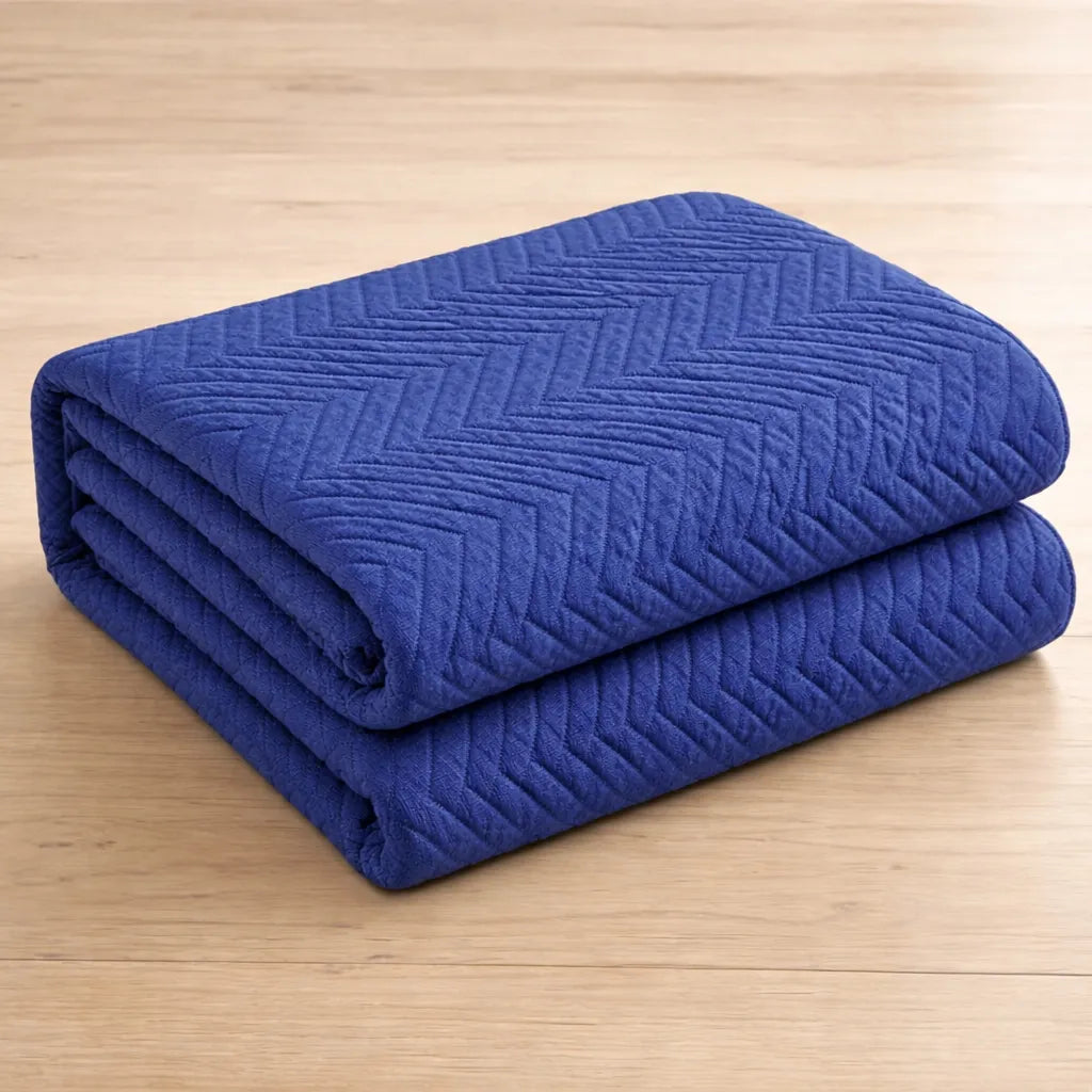 Folded blue quilt on a wooden surface