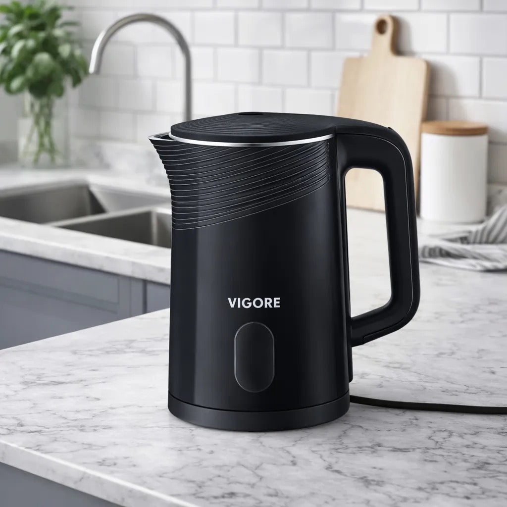 Black electric kettle on a kitchen counter with 'Vigore' branding.